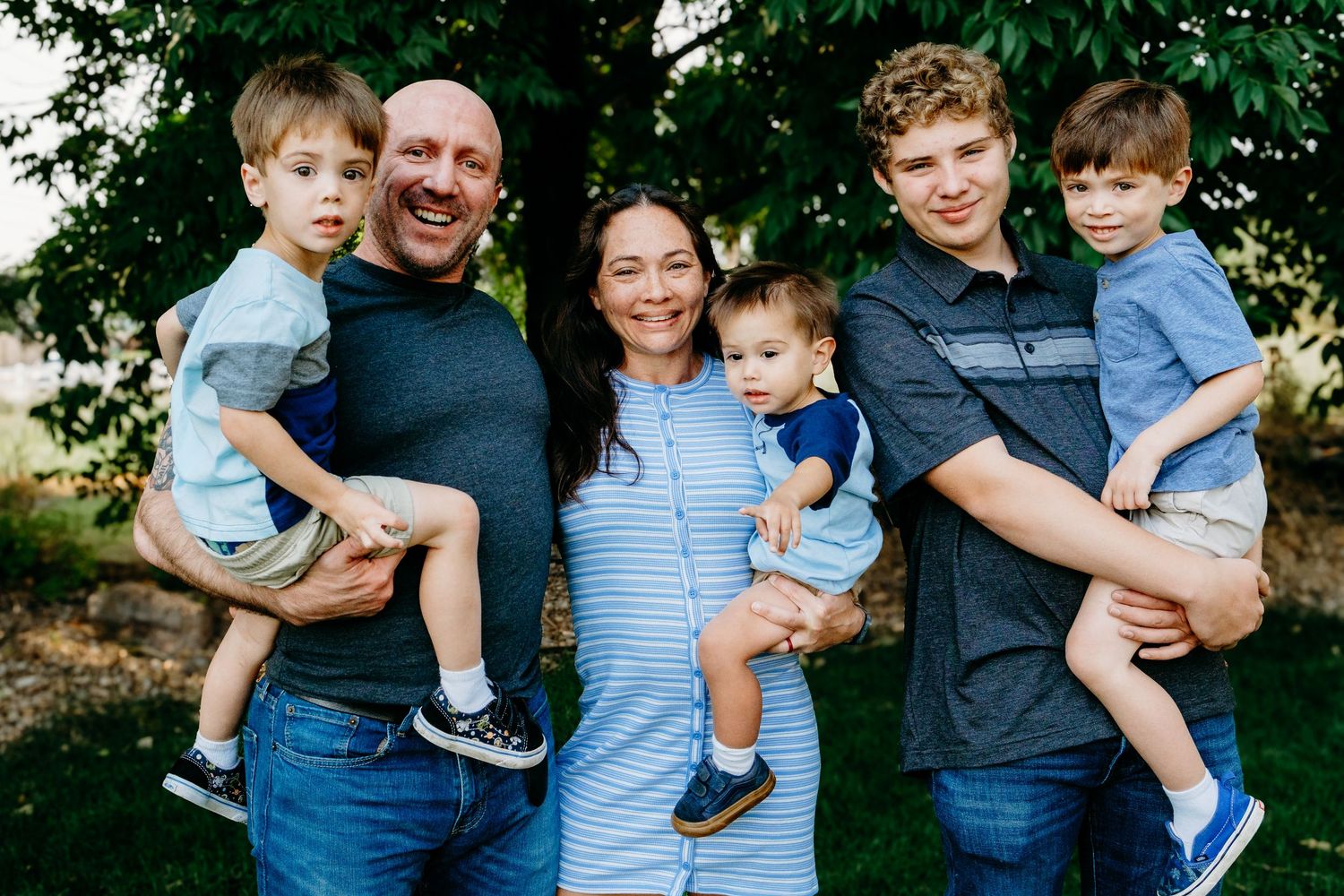 Posed family portrait of parents and four sons.