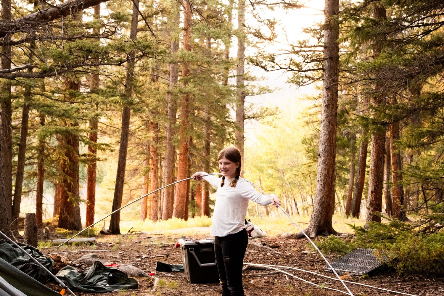 Documentary portraits of family putting together tent in mountains of Colorado.