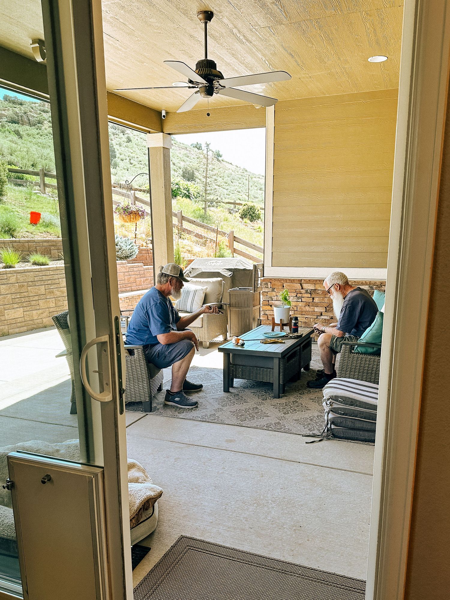 Denver photographer's project 365, June, two adult men sitting on porch in conversation.