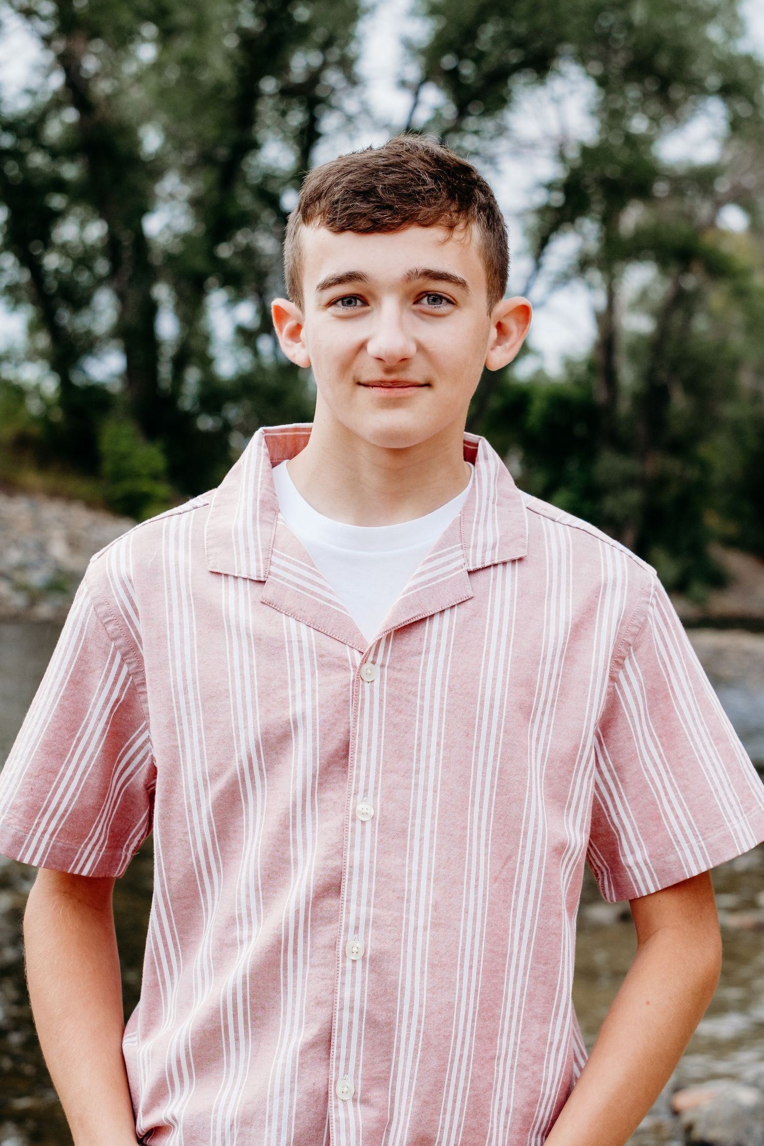 Close up of teen boy near Cache la Poudre river in Fort Collins. Captured by a Denver senior photographer.