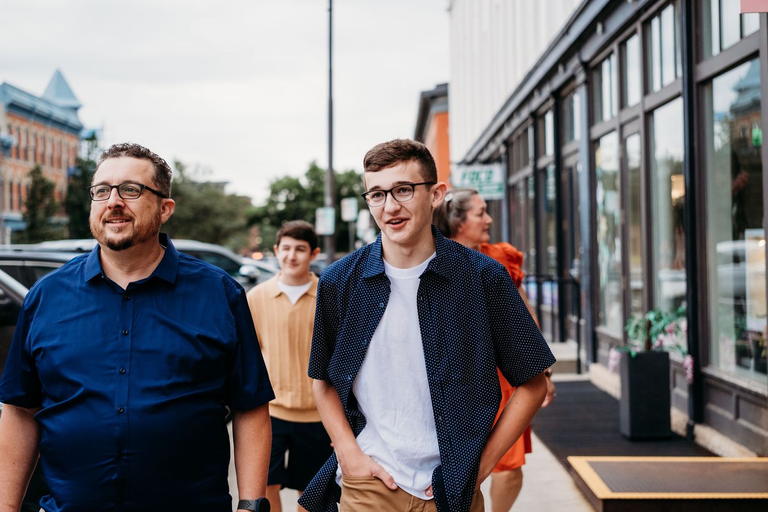 Candid portrait of family of four walking in downtown Fort Collins.