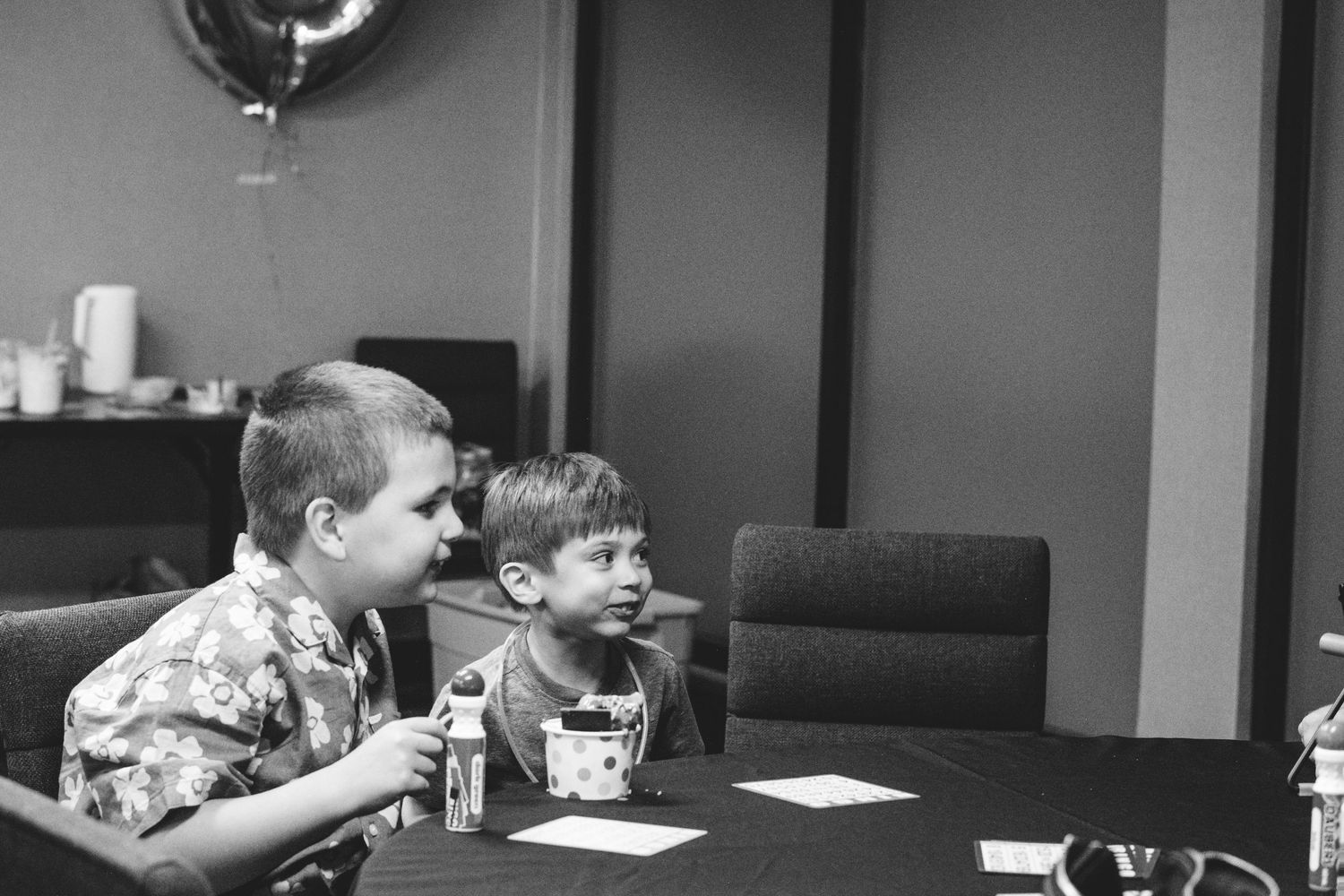 Black and white of young cousins playing bingo together.