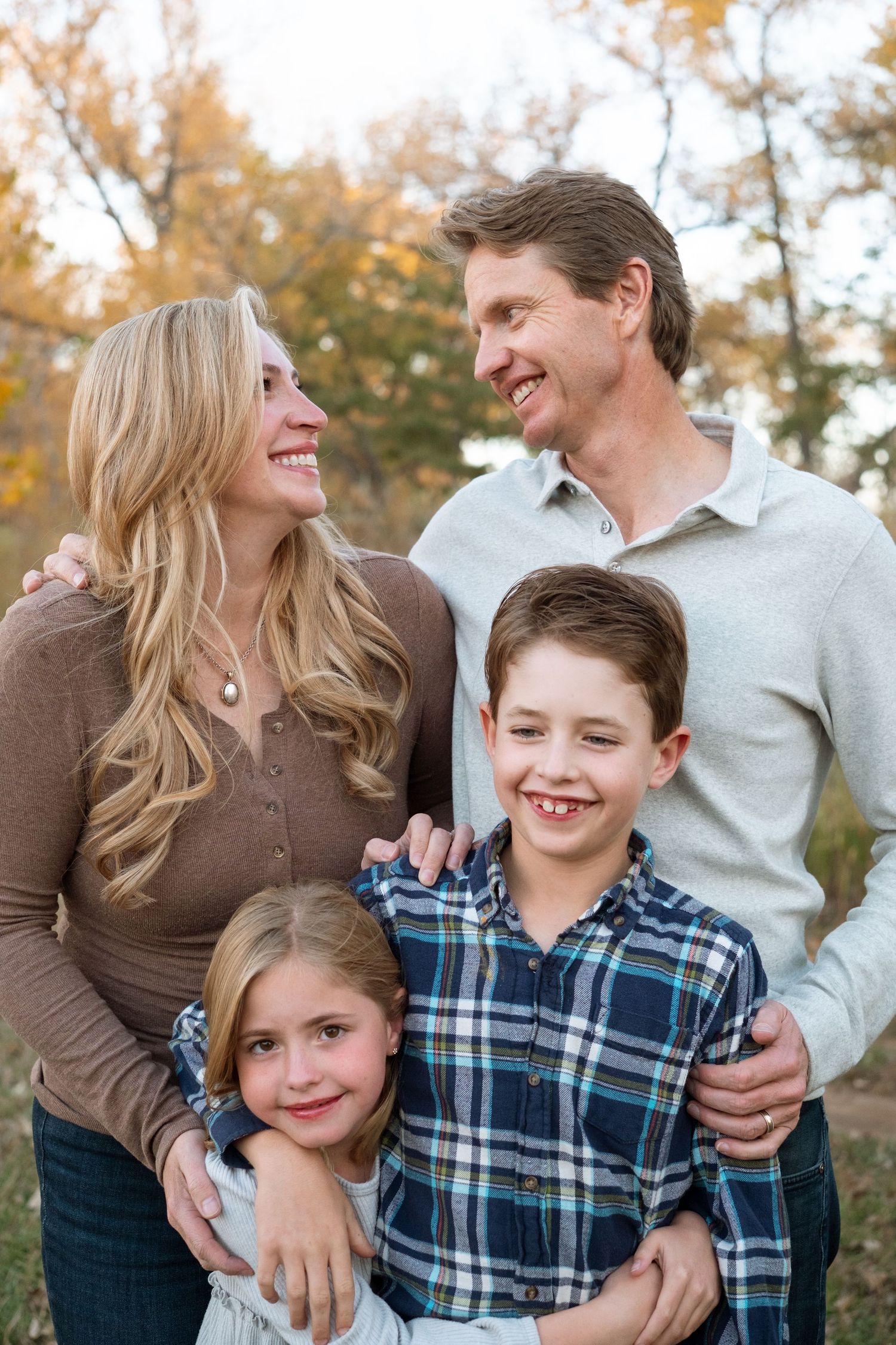 Close up of family of four, including mother, father, daughter and son at Bear Creek Lake Park in Lakewood.