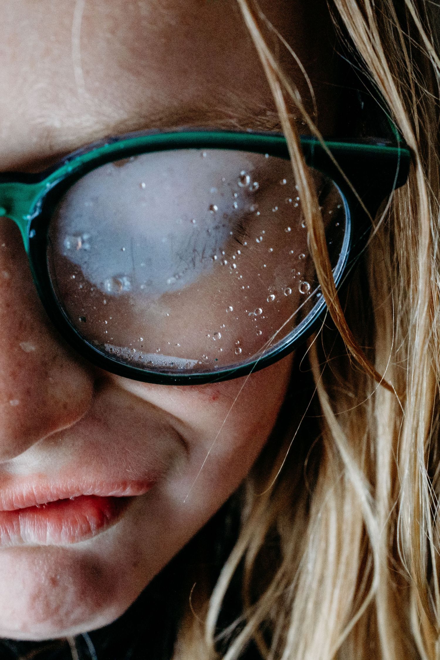 Close up of girl with foggy glasses with consensation.