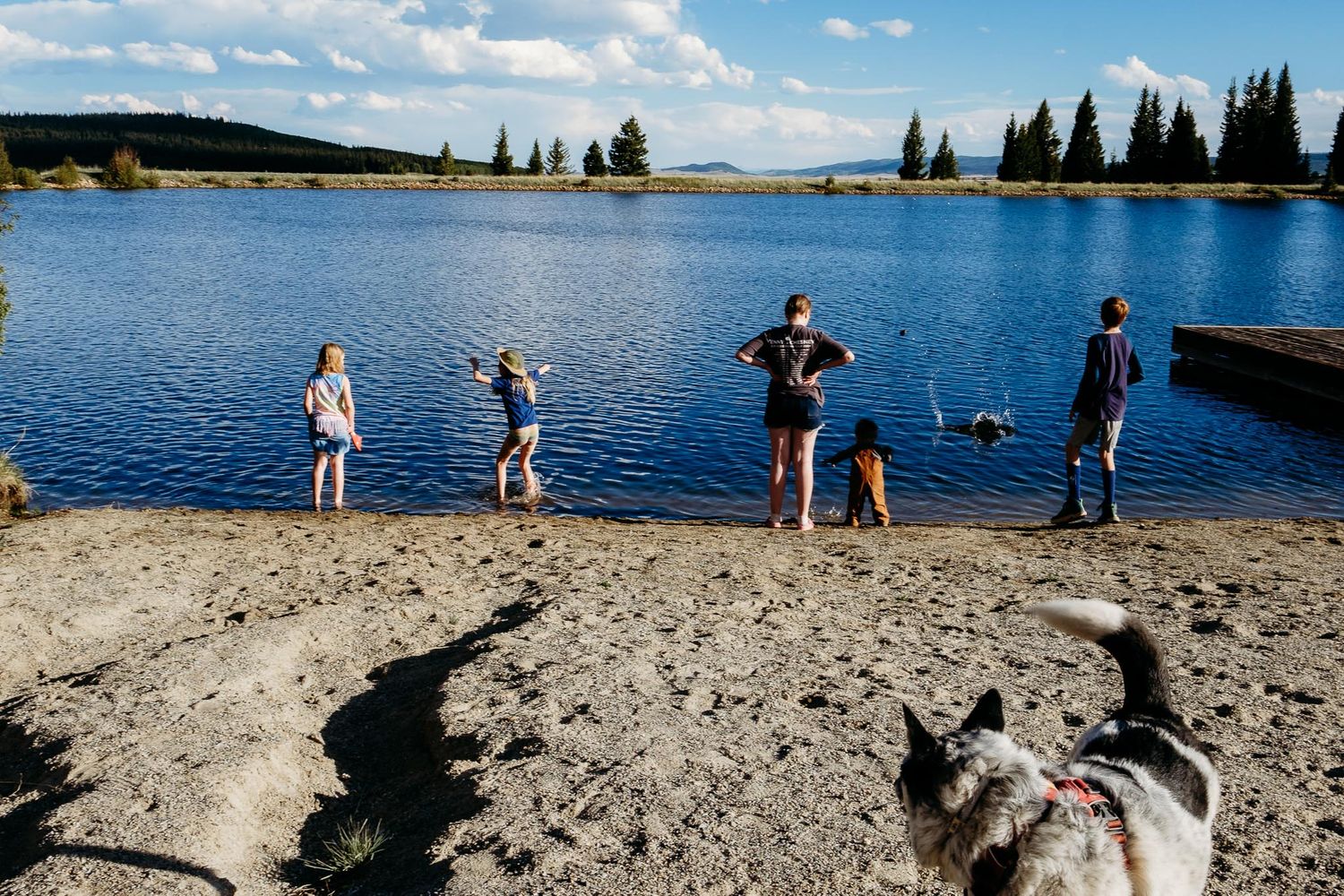 Denver photographer's project 365, June, children playing at shoreline of mountain lake, blue skies with white clouds in distance.