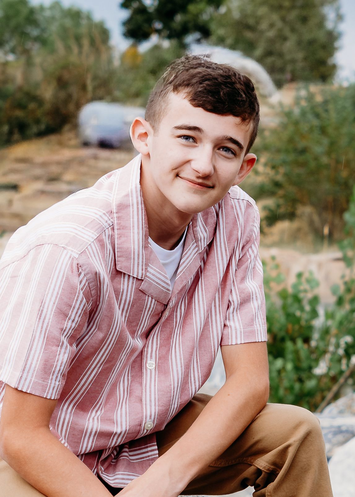 Close up of teen boy near Cache la Poudre river in Fort Collins. Captured by a Denver senior photographer.
