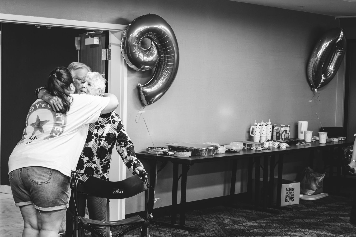 Grandmother's surprise reaction for her surprise 90th birthday party, hugging granddaughter.