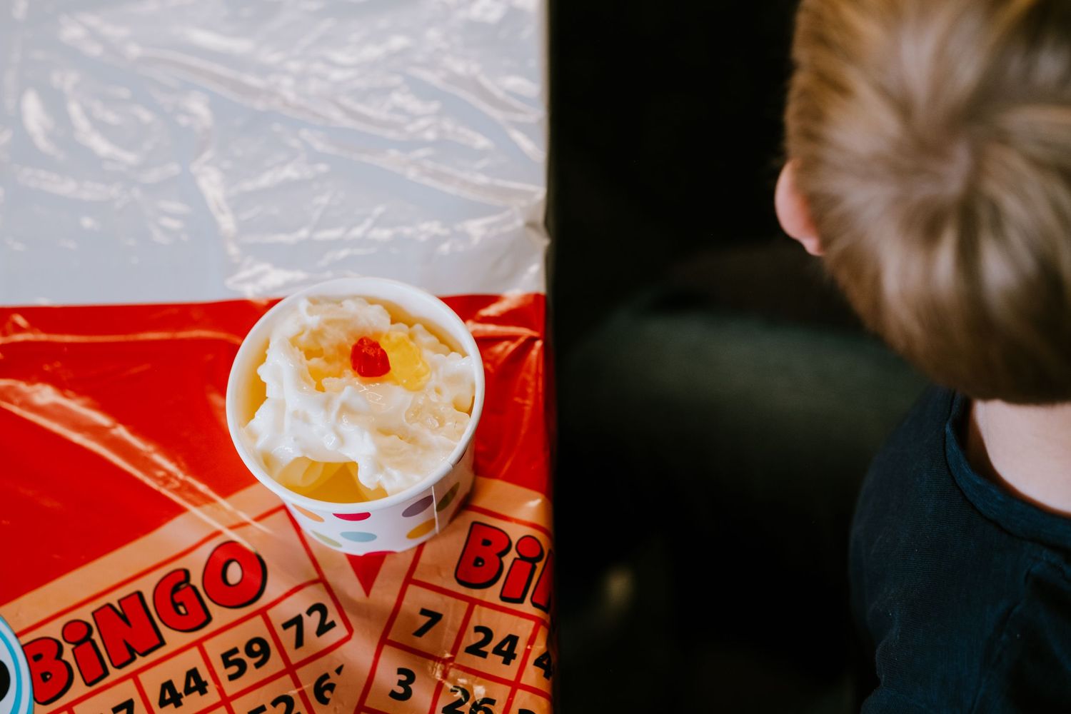 Overhead view of young boy eating ice cream.