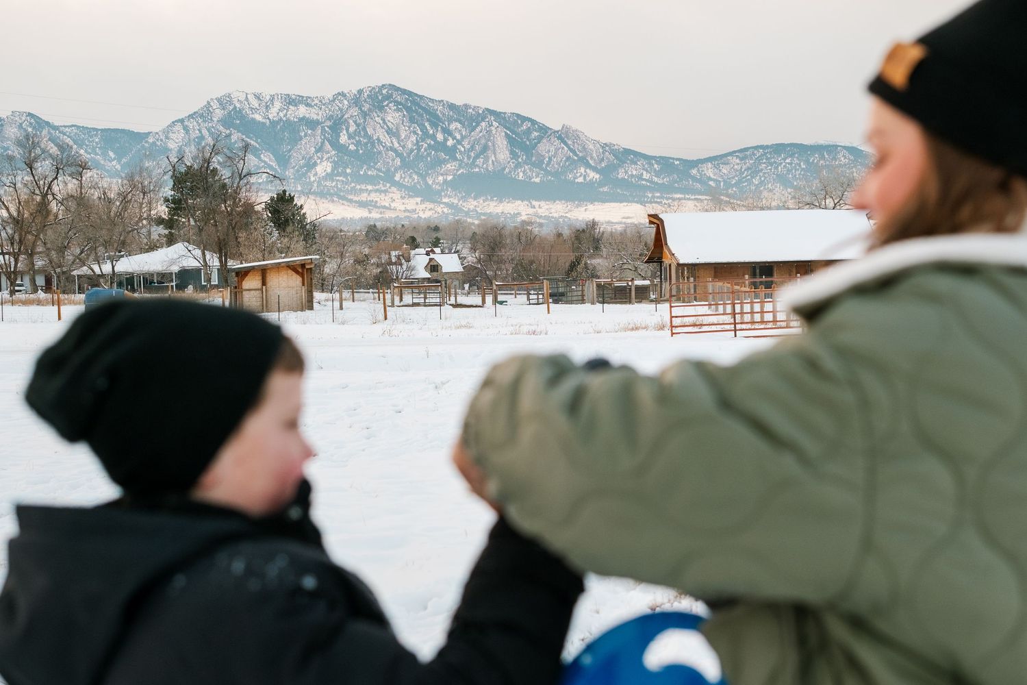Project 365 - flat irons view in background, mother putting on son's glove in foreground.