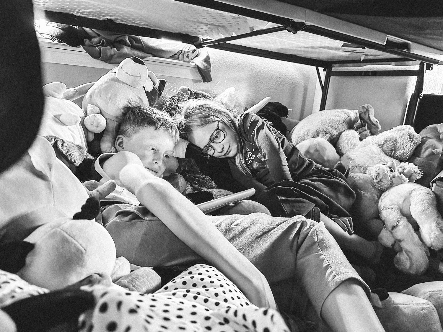 Denver photographer's project 365, May, black and white of children watching tablet in a fort they made.