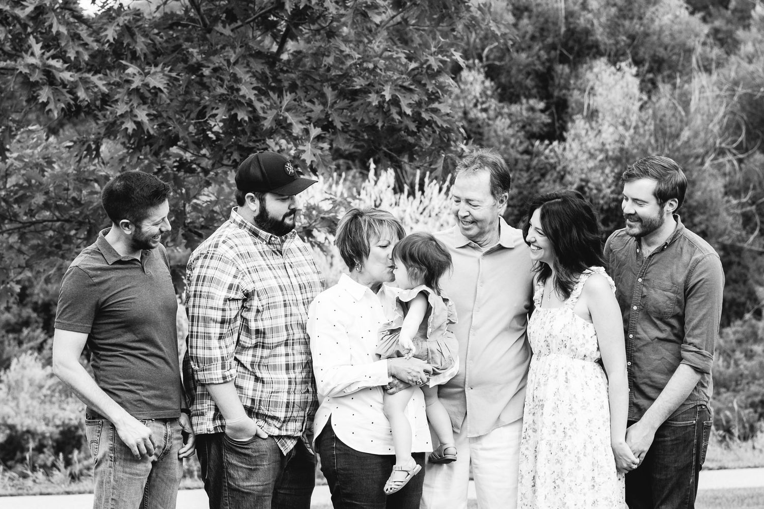 Black and white portrait of multi generation family photo at park.