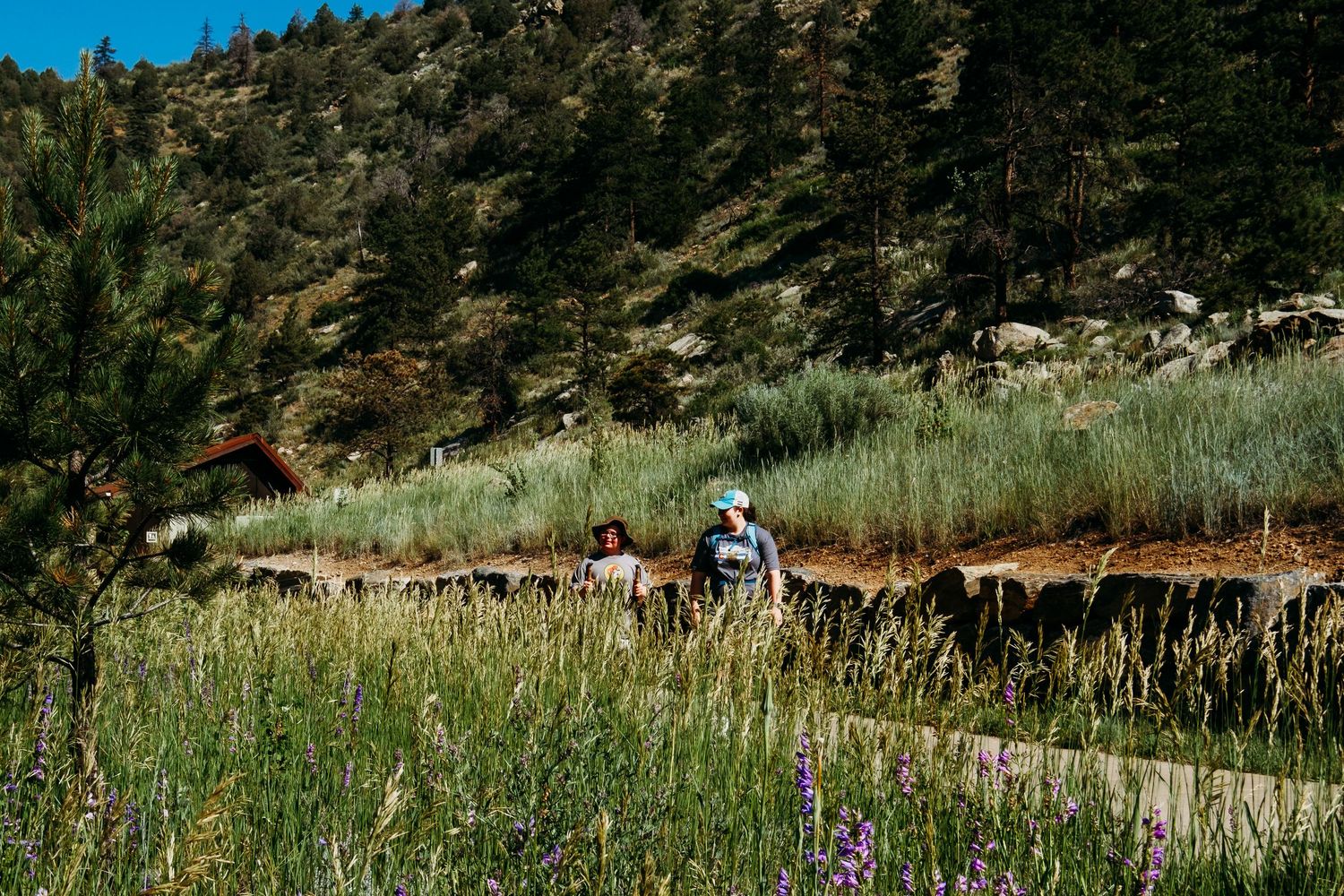 Two participants of an inclusive hike at Clear Creek Trail in Golden, Colorado.