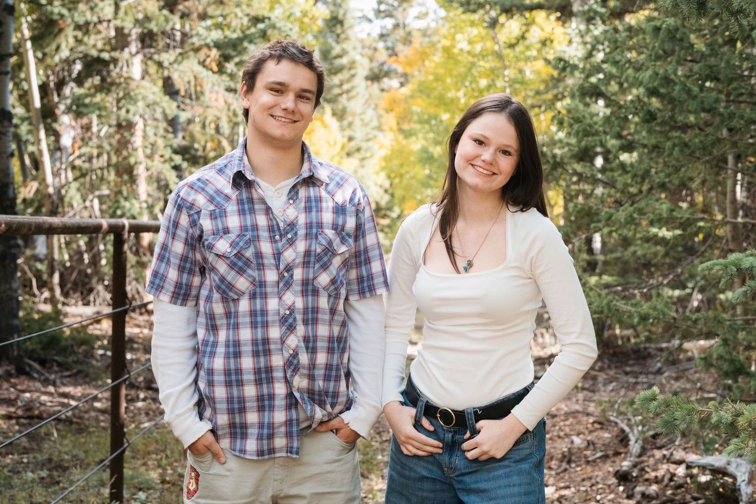 Playful portrait of siblings in forest near Colorado national park.