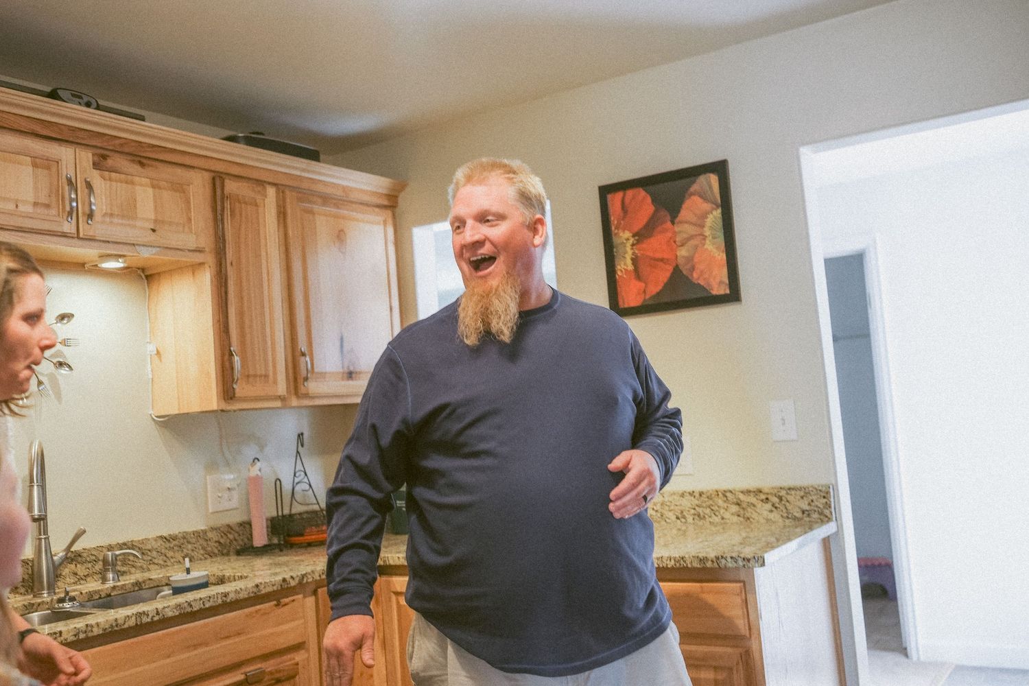 Denver family having a playful dance party in kitchen.