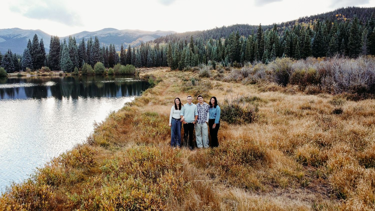Drone portrait of family with teenagers in Colorado mountains, surrounded by fall foliage in Colorado mountains.