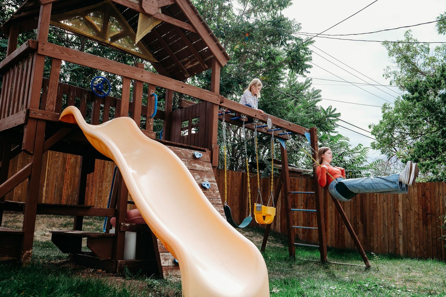 In-home Denver family photography session,  sisters playing in backyard.