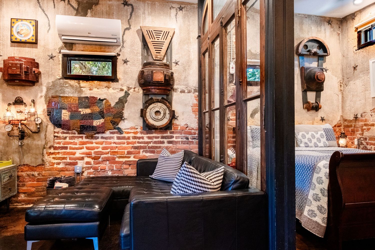 Airbnb photo - eclectically decorated living room with peak into bedroom.