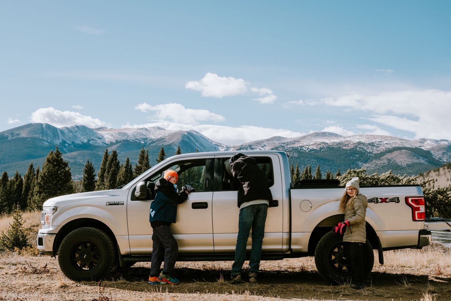 Project 365 - father and children at truck collecting Christmas tree in mountains of Colorado.