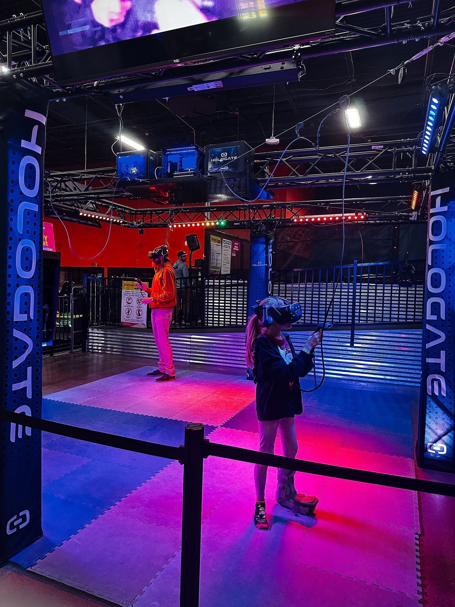 Project 365 - father and daughter playing VR game at trampoline park.