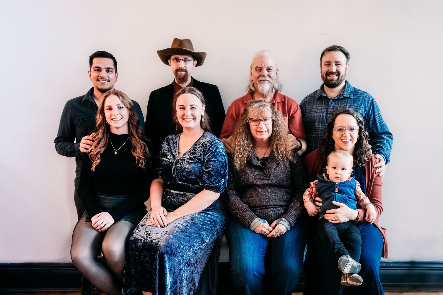 Studio portrait of extended family, including two grandparents, three children and two spouses and one grandchild,.