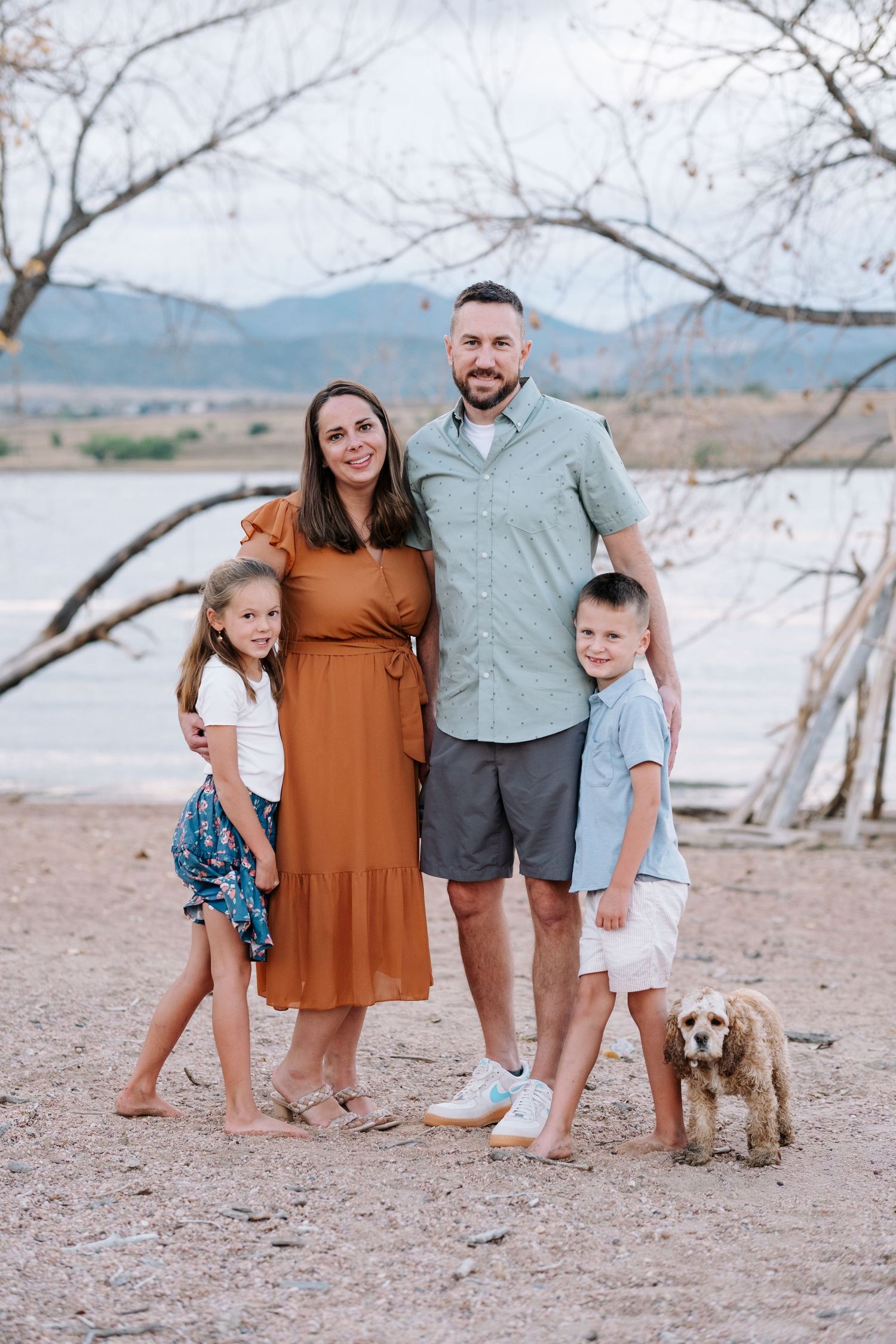 Family of four standing with dog, at Chatfield State Park in Littleton, Colorado.
