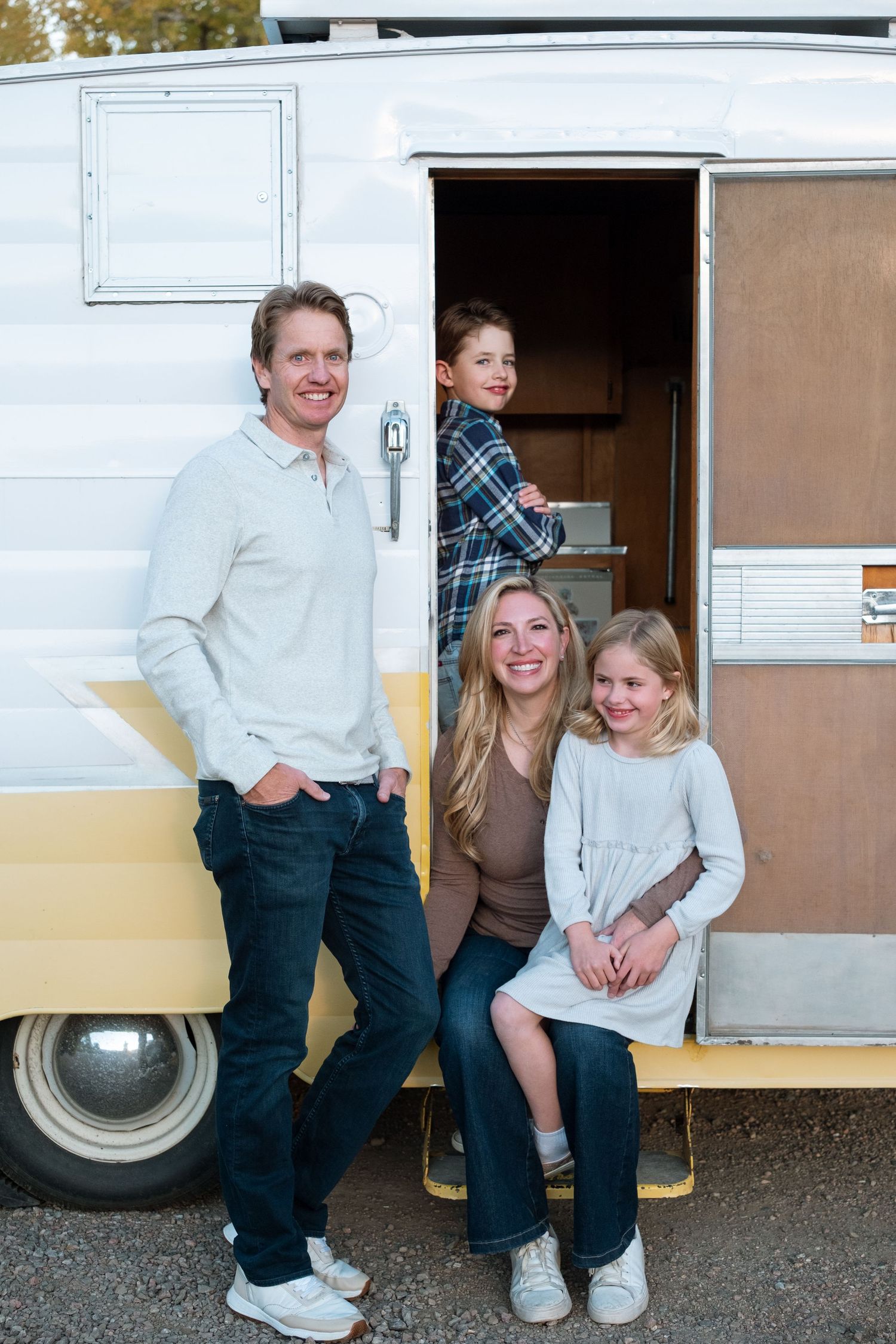 Close up offamily in front of vintage Shasta trailer at Bear Creek Lake Park in Lakewood, Colorado.