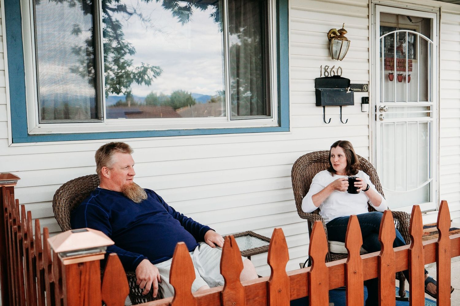 In-home Denver family photography session,  husband and wife enjoying coffee on front porch.
