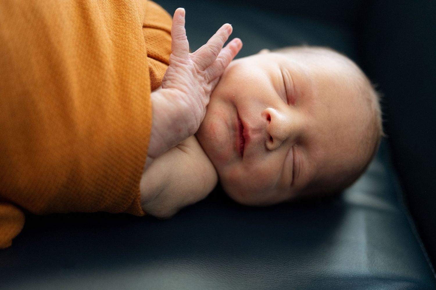 Close up of newborn sleeping in hospital room.