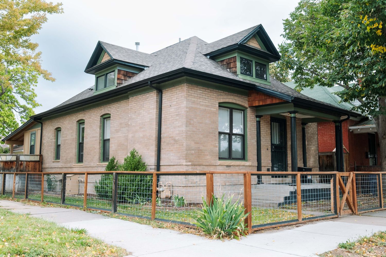 Airbnb photo Denver Colorado professional Denver photographer, main view of exterior of brick home with wood fence.