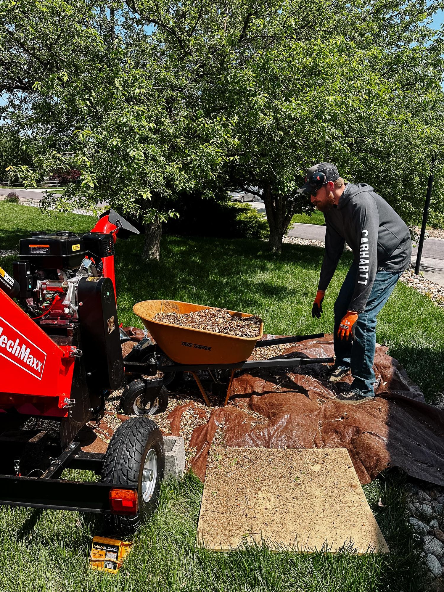 Denver photographer's project 365, June, man holding wheelbarrow near wood chipper.