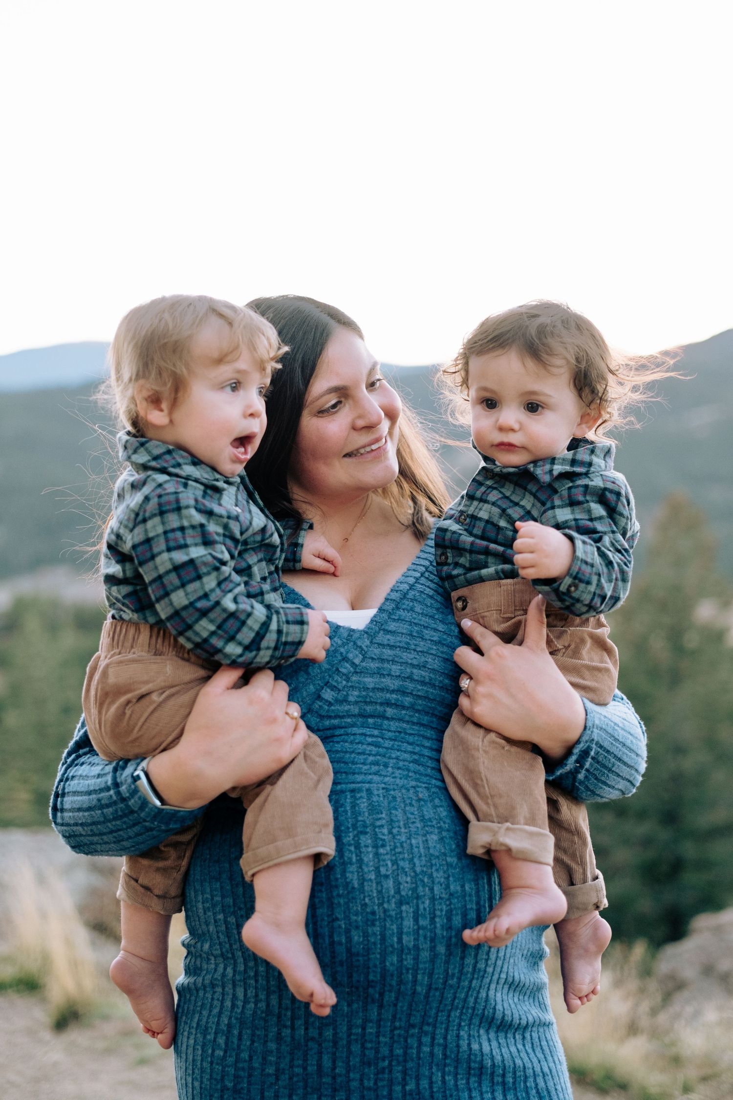 Pregnant mother holding twin one year olds in matching outfits at Mt Falcon West in Indian Hills.