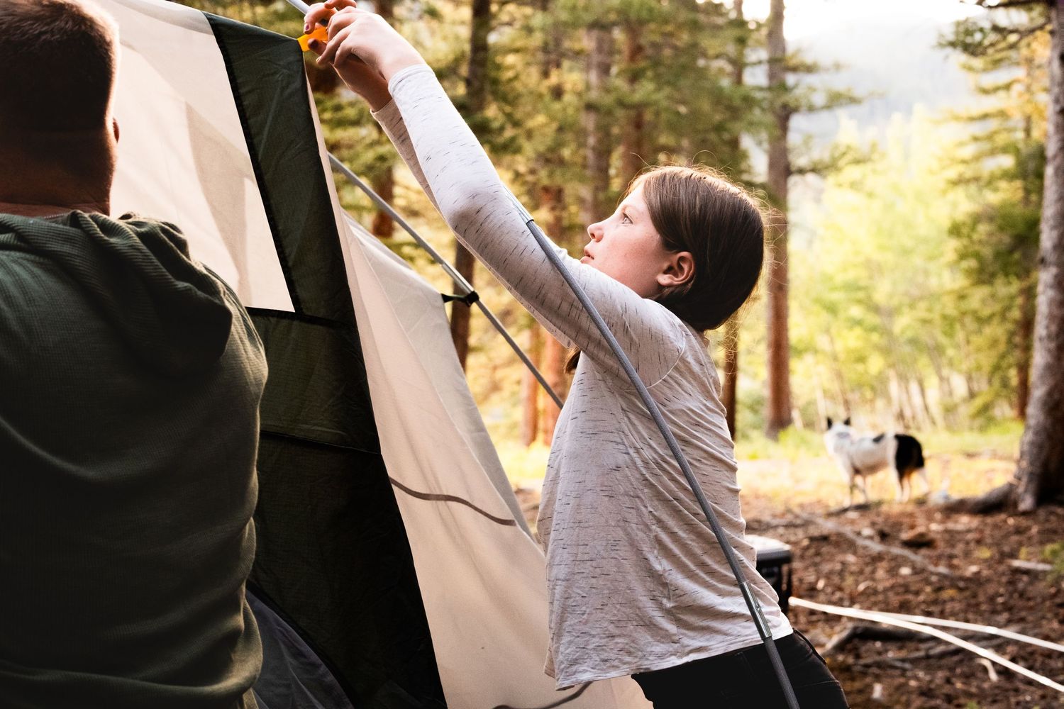 Documentary portraits of family putting together tent in mountains of Colorado.