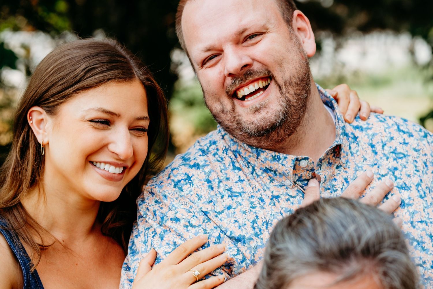 Two adults laughing and smiling together.