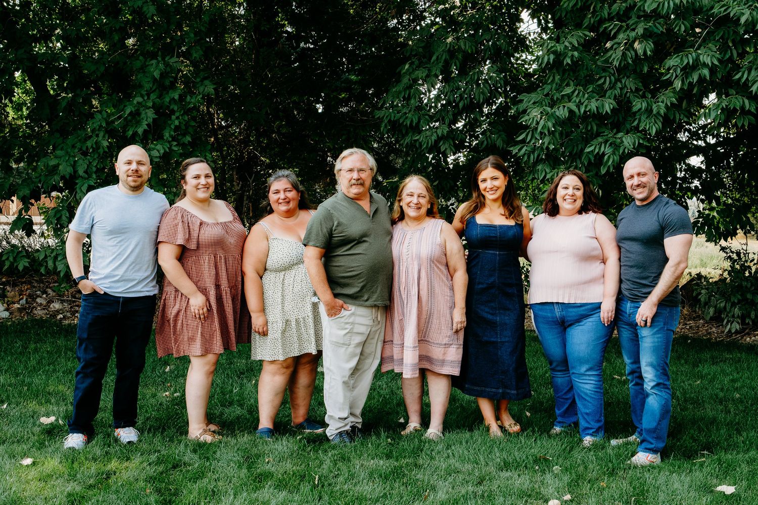 Posed family portrait of parents and six adult children.