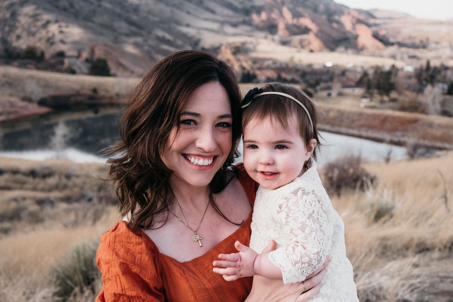 Close up of mother and baby girl standing in Mount Falcon East in Morrison, Colorado.