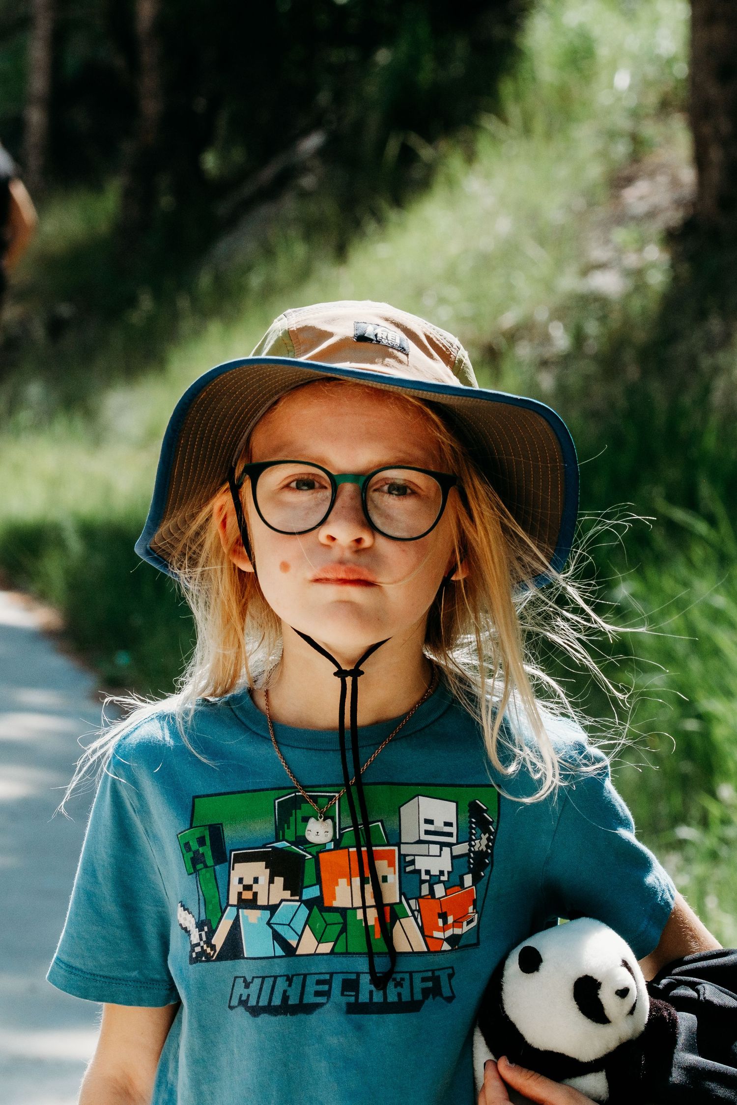 Denver photographer's project 365, June, young girl wearing sun hat, hiking, with serious expression.