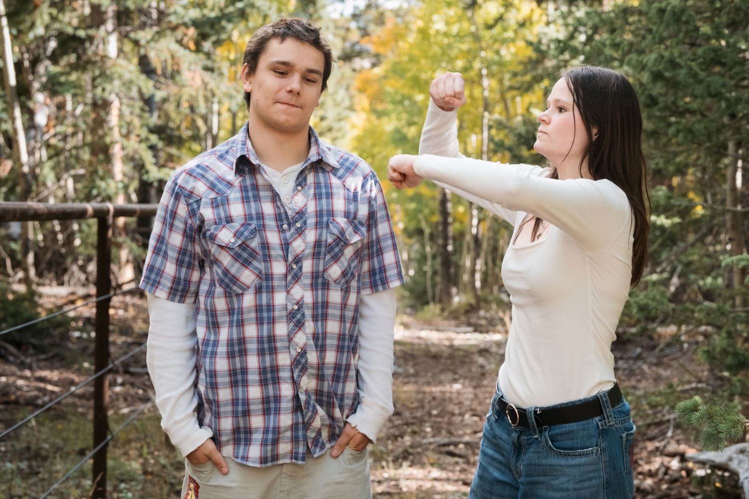 Playful portrait of siblings in forest near Colorado national park.