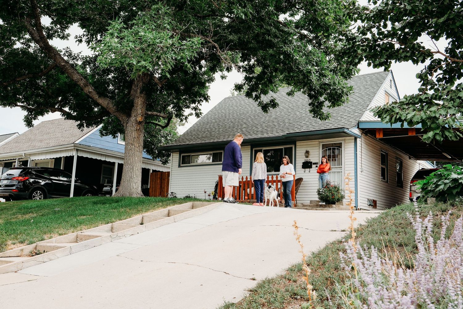 In-home Denver family photography session, family of four standing in front of home near Ruby Hill.