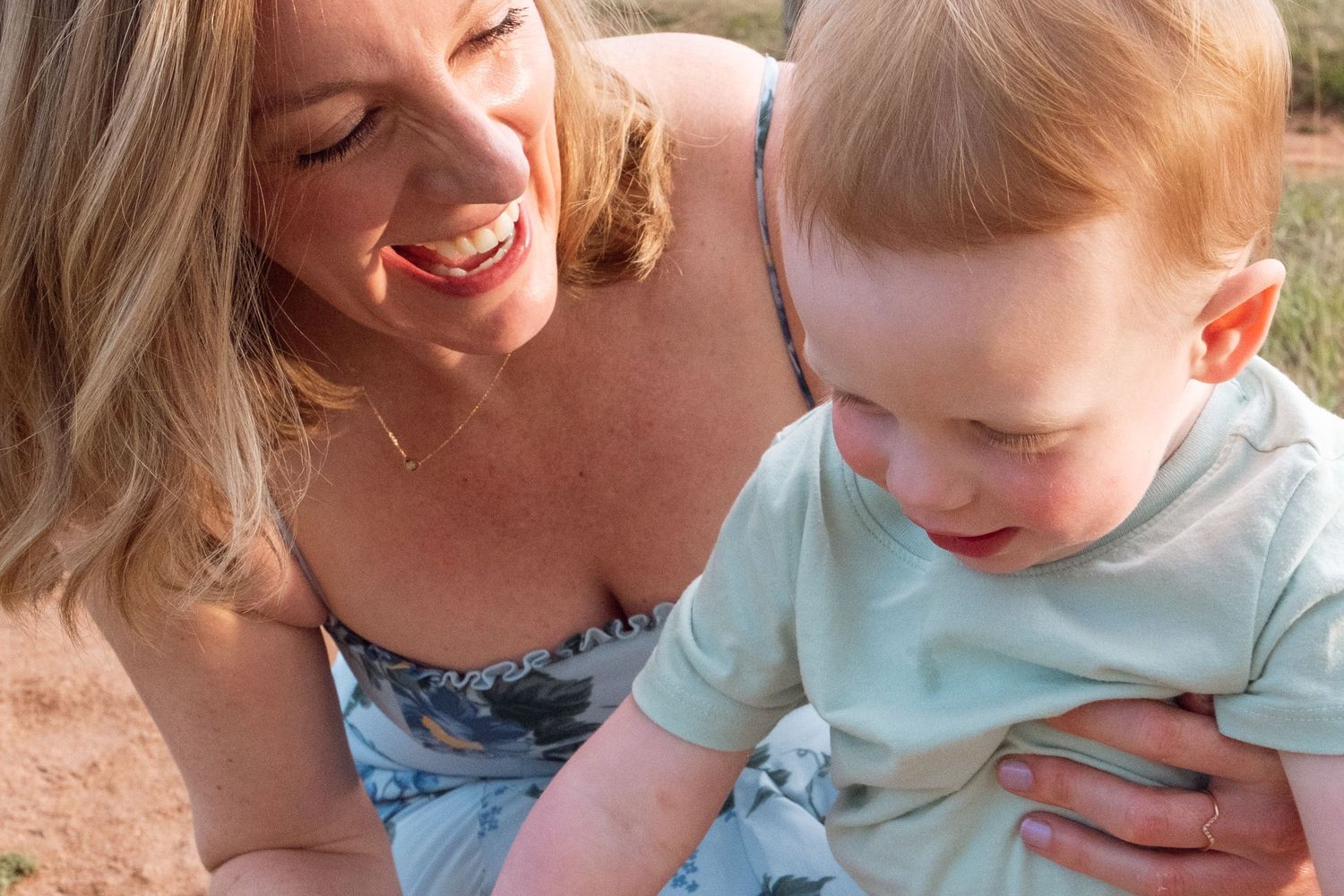 Close up of mother and son playfully laughing.