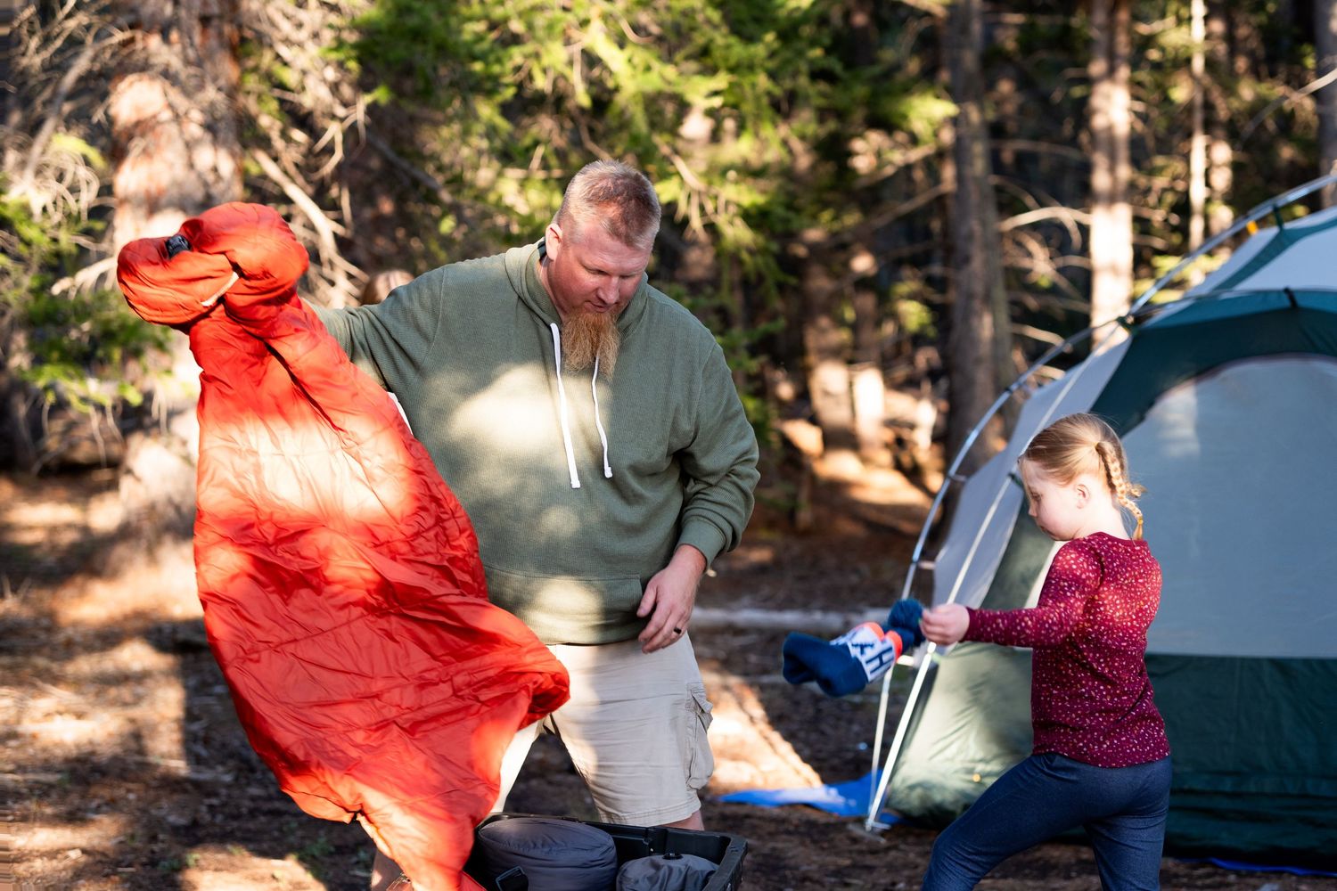 Documentary portraits of family putting together tent in mountains of Colorado.