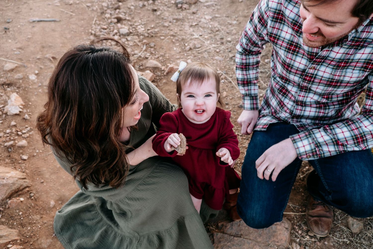 Mother, father and toddler daughter playing on trail at Mount Falcon East.