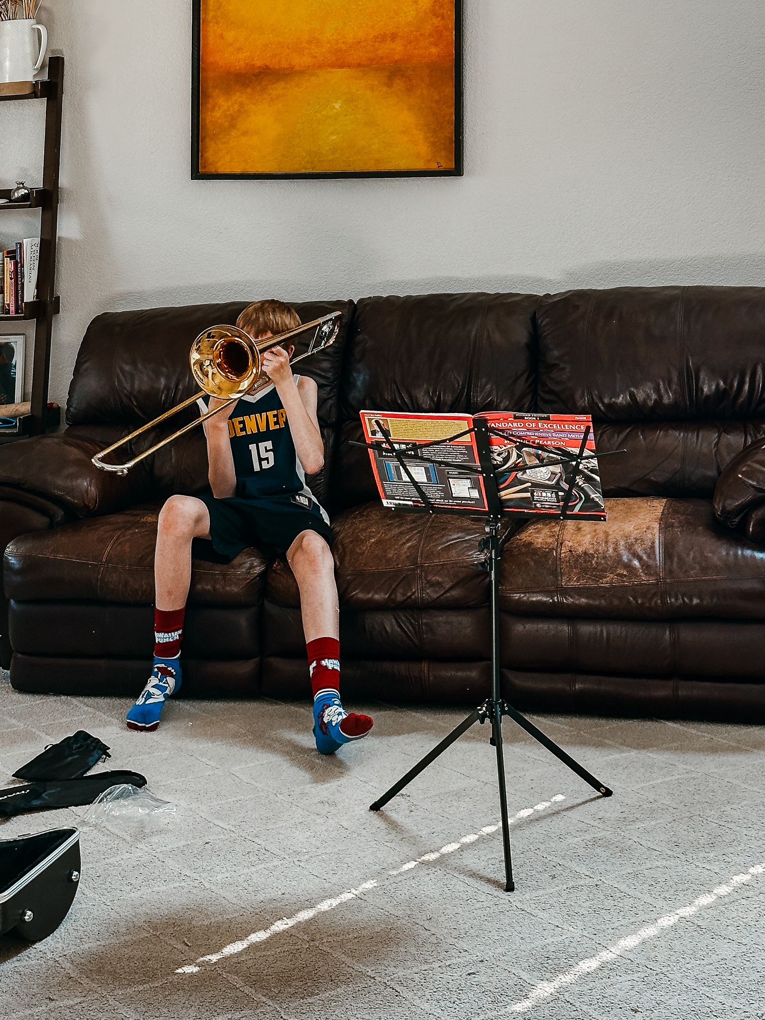 Project 365 photo - boy practicing trombone in living room.