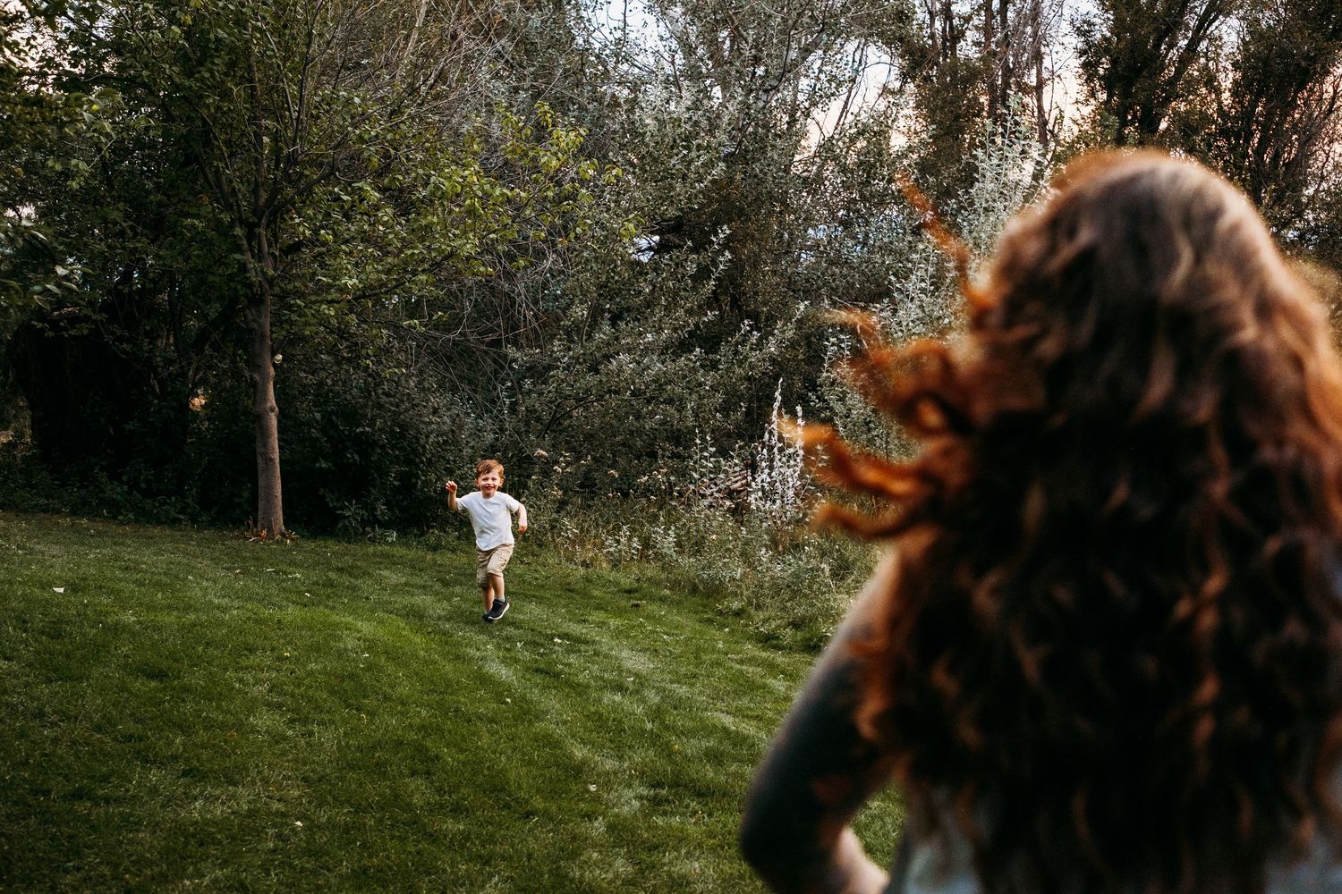 Mother running toward toddler in park in Arvada, Colorado