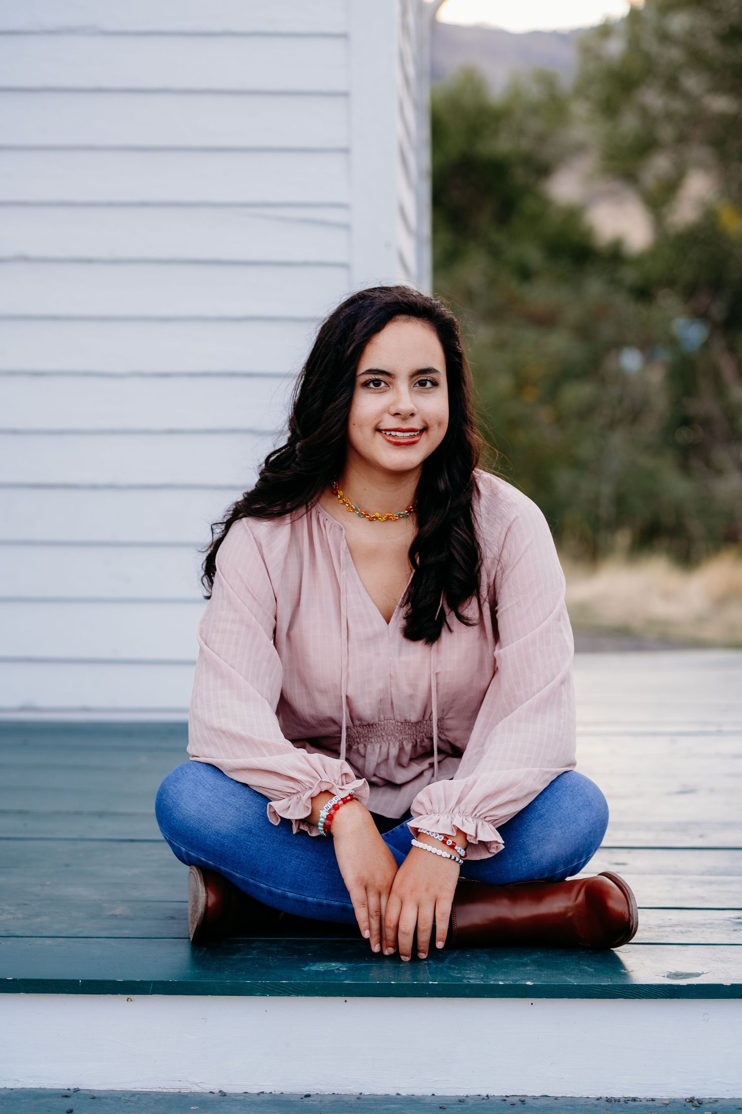 Senior portrait of teen sitting at the top of the steps at Golden History Park.