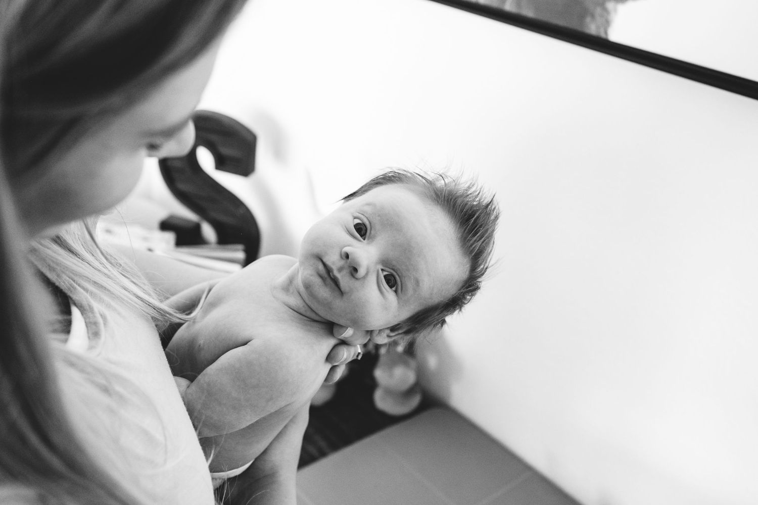 Black and white of newborn making precious expression during Denver in-home photo session.