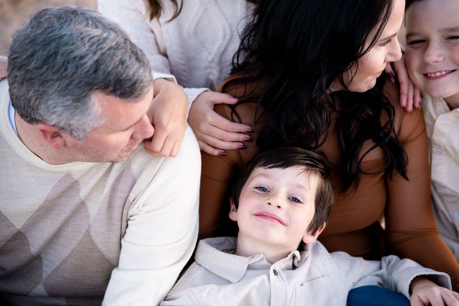 Close up of snuggling family.