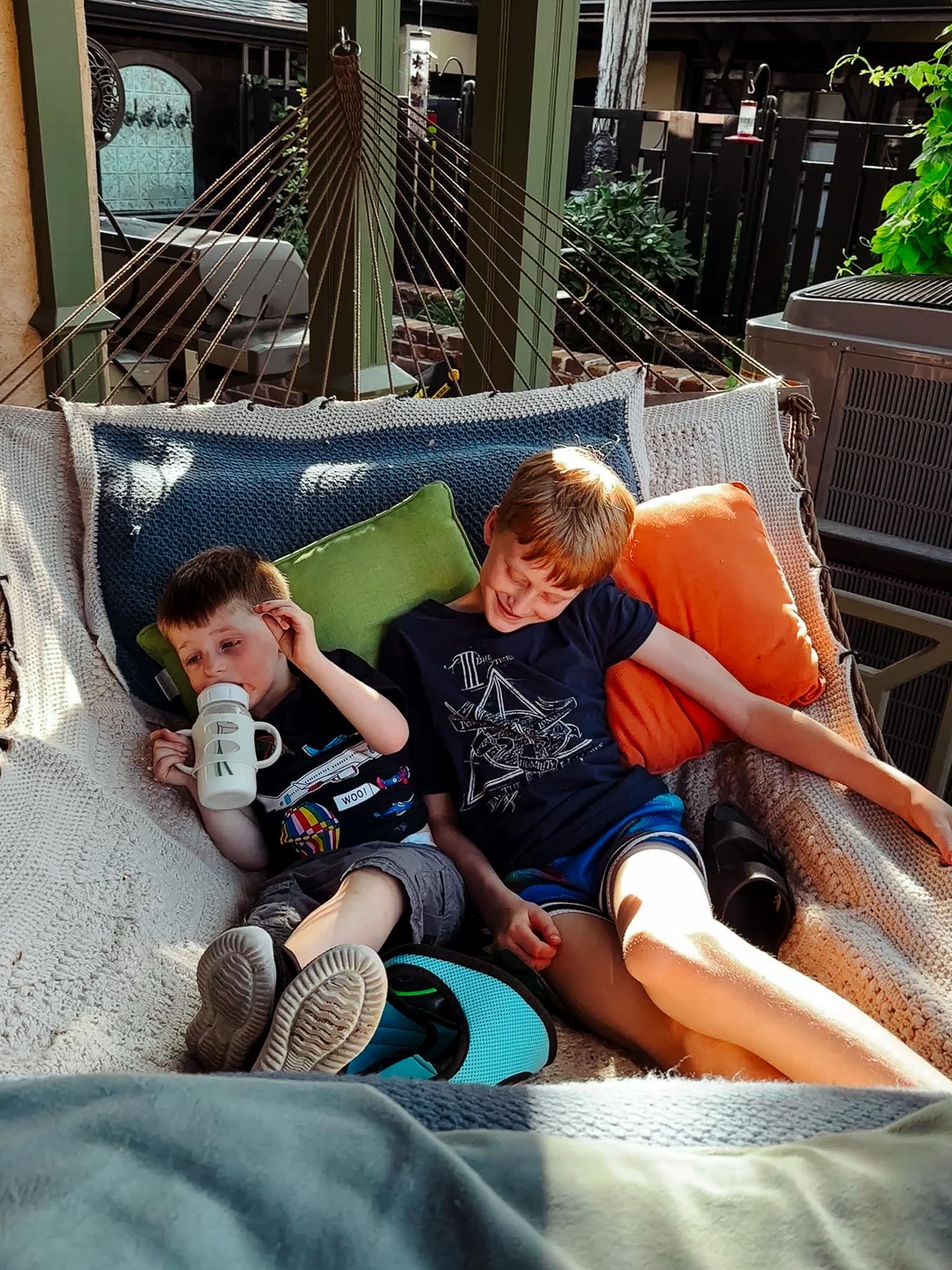 Denver photographer's project 365, June, two boys sitting close together on hammock.