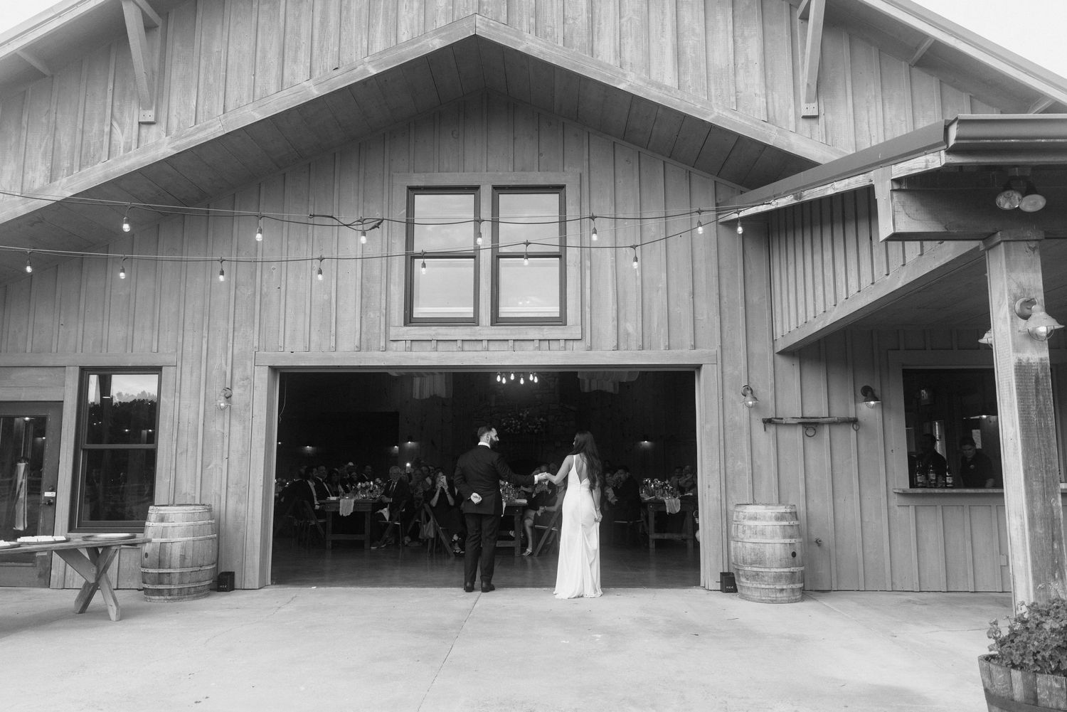 Rustic wooden barn exterior with multiple doorways and entrances.