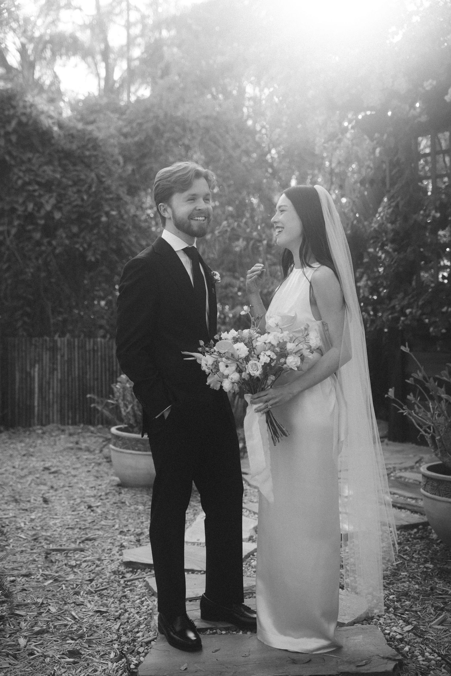 A series of romantic black and white wedding photos showing a couple in a garden setting.