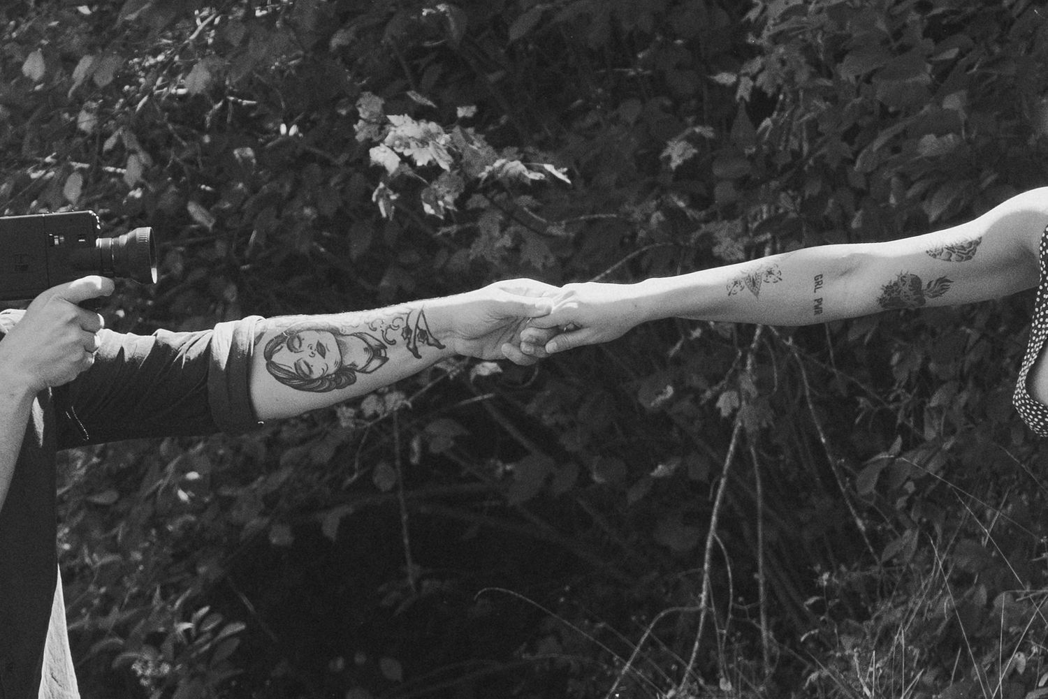 Black and white photo series showing extended arms reaching across frames.
